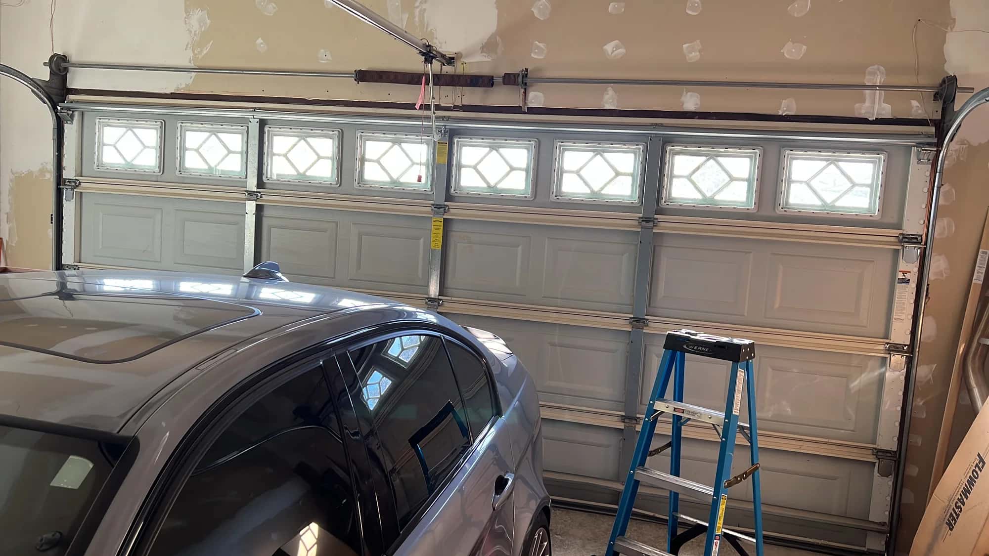 White garage door with windows from inside the garage