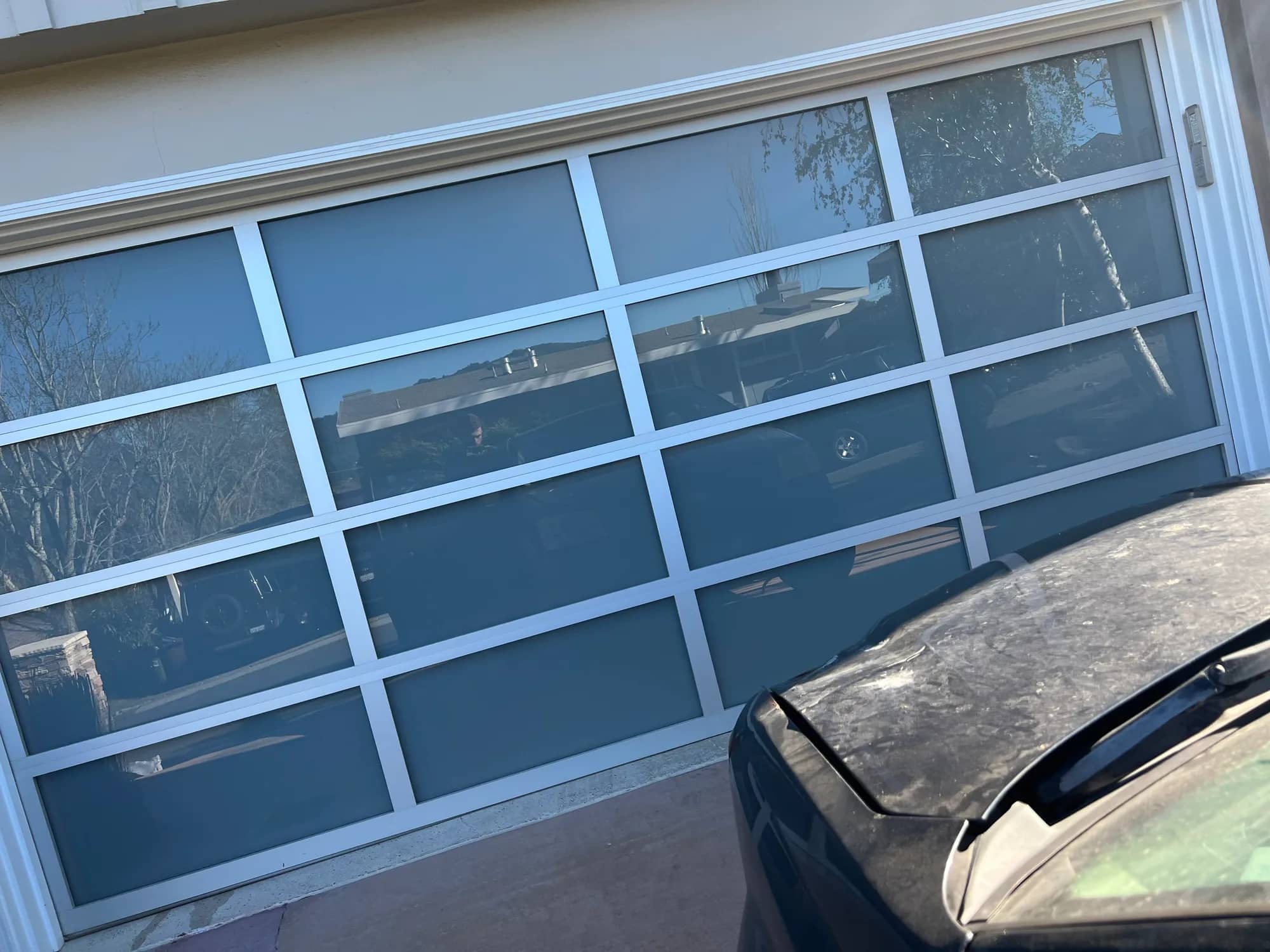 Black-frame full-view glass garage door