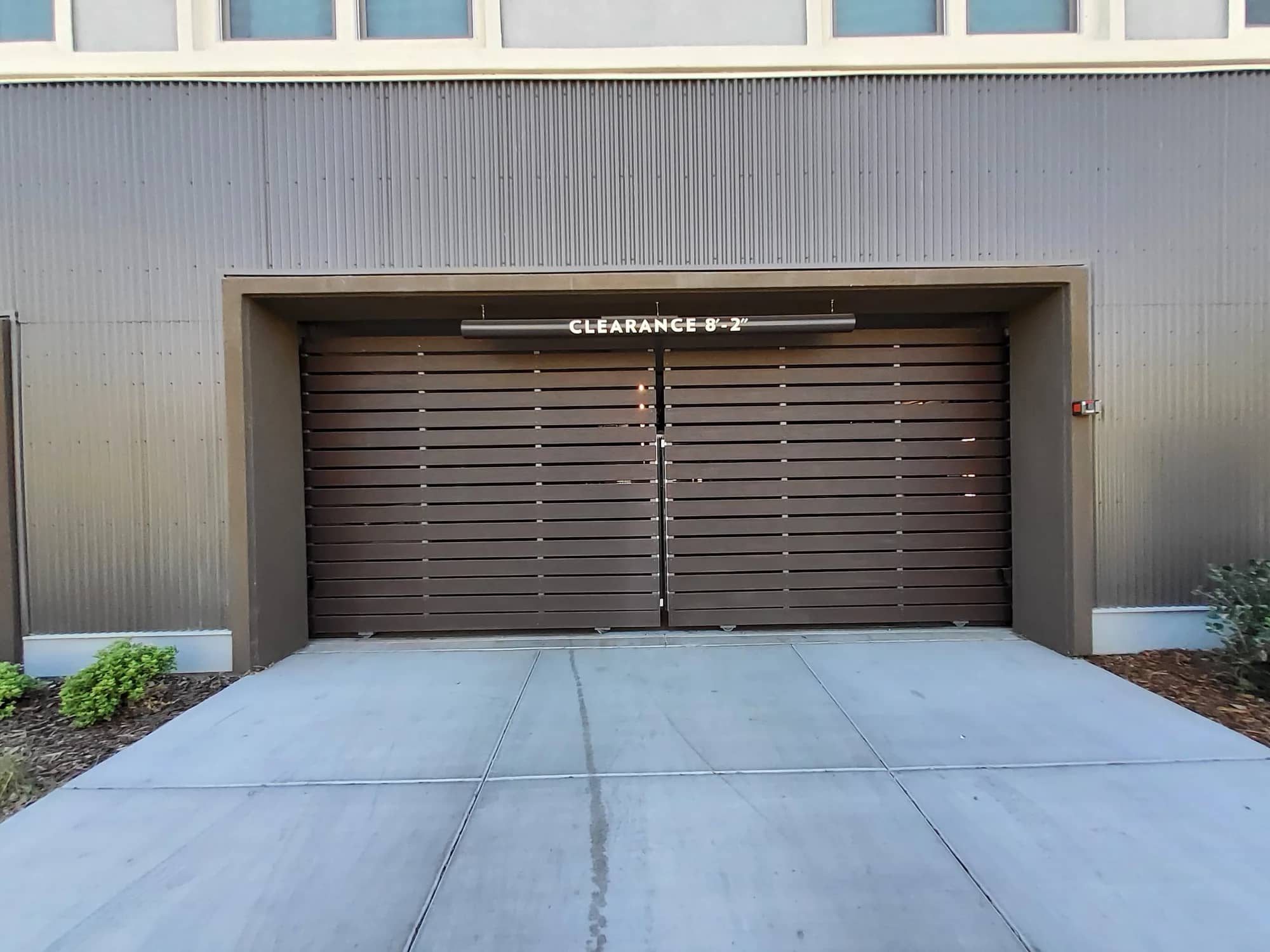 Brown horizontal slat garage door on a metal building