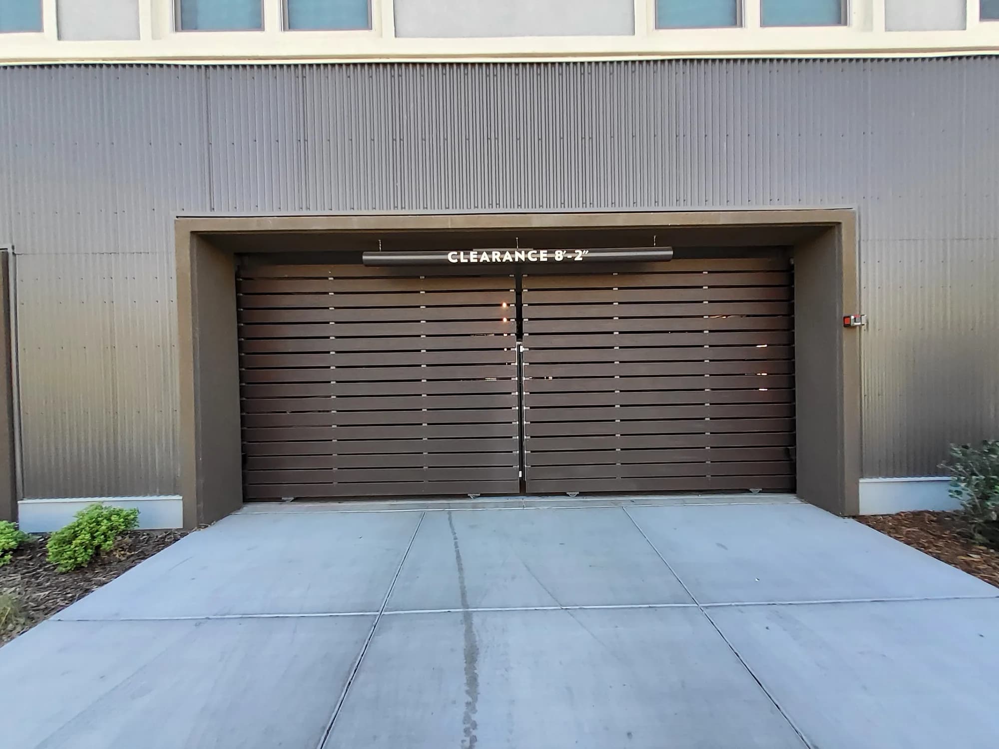 Brown horizontal slat garage door on a metal building