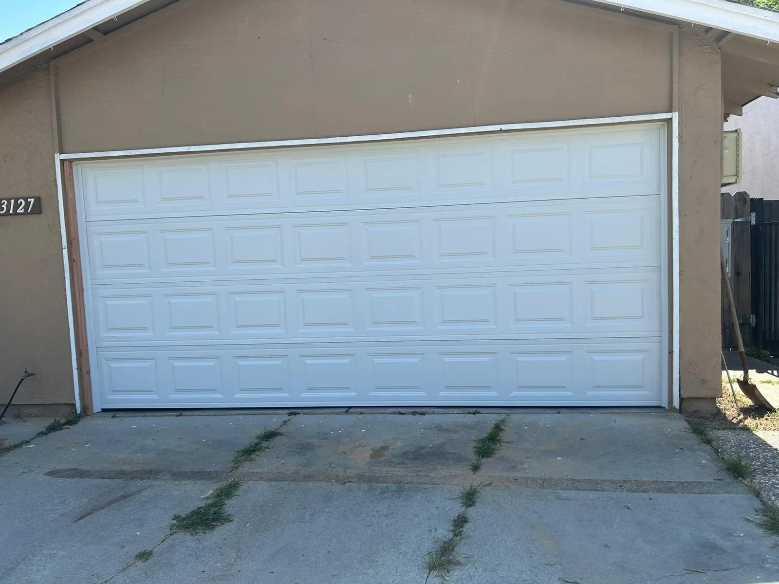 White double sectional garage doors on a home