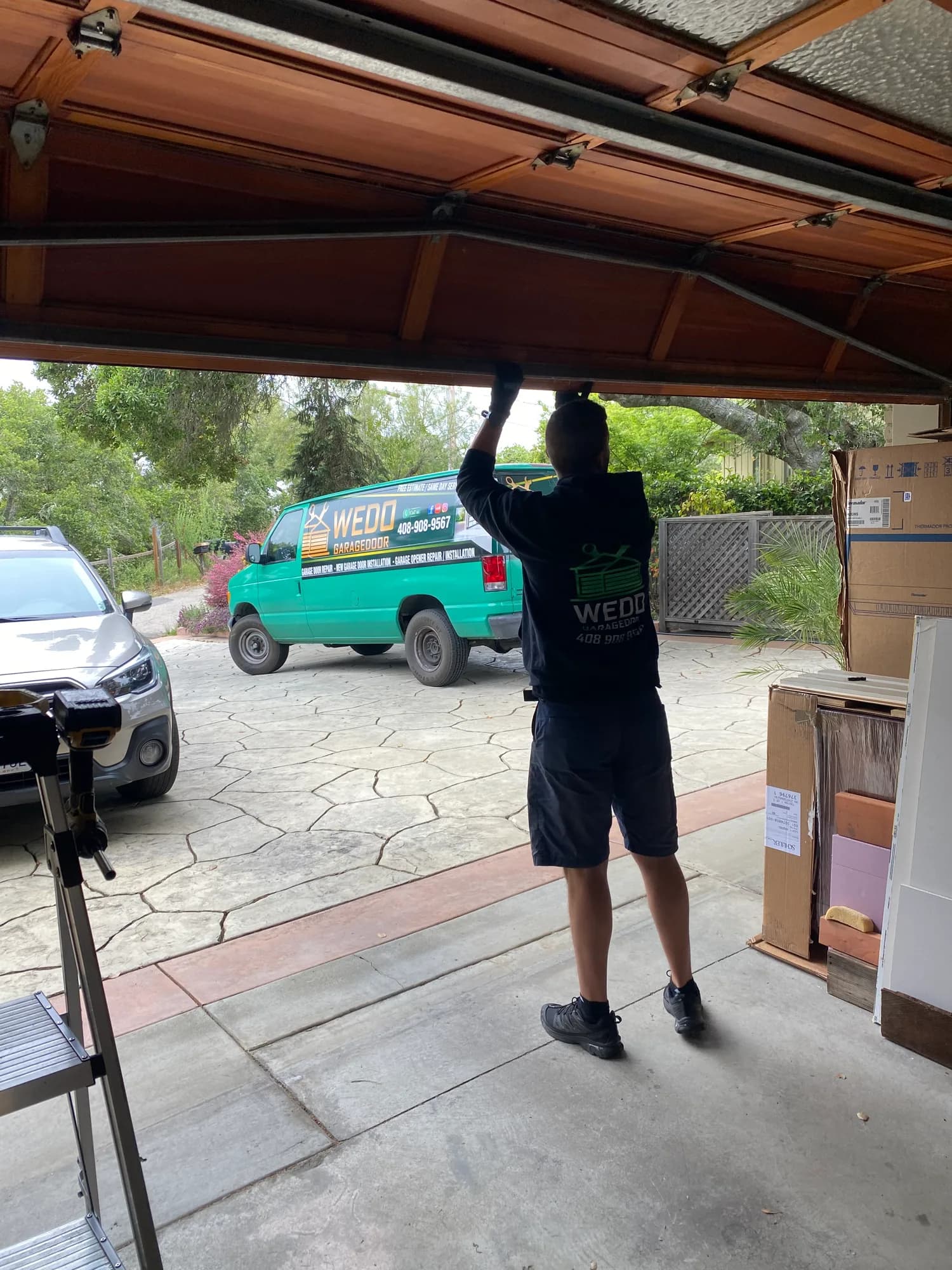 WeDo technician on site with the green service van in the driveway