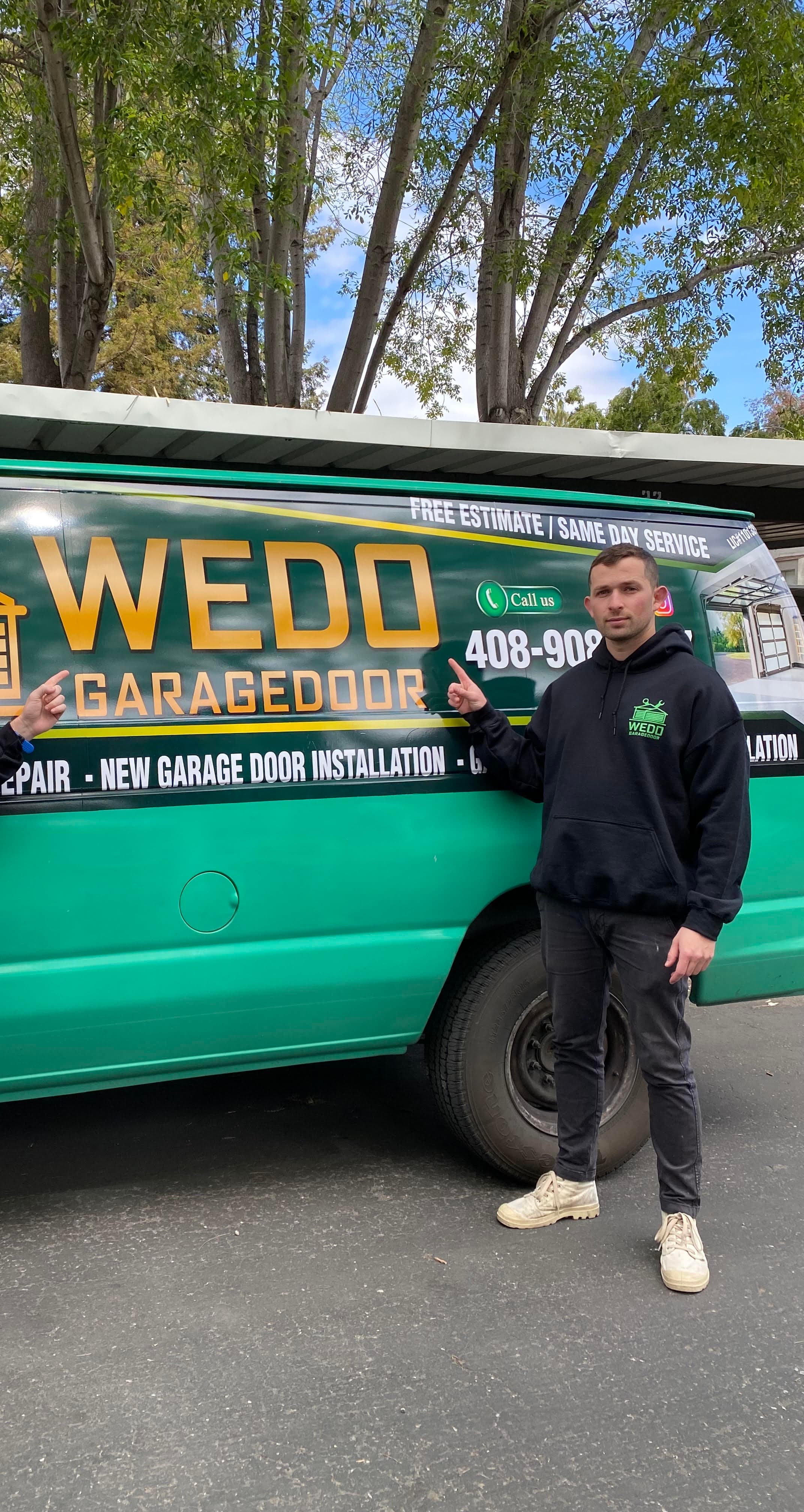 WeDo GarageDoor technician standing beside the green service van