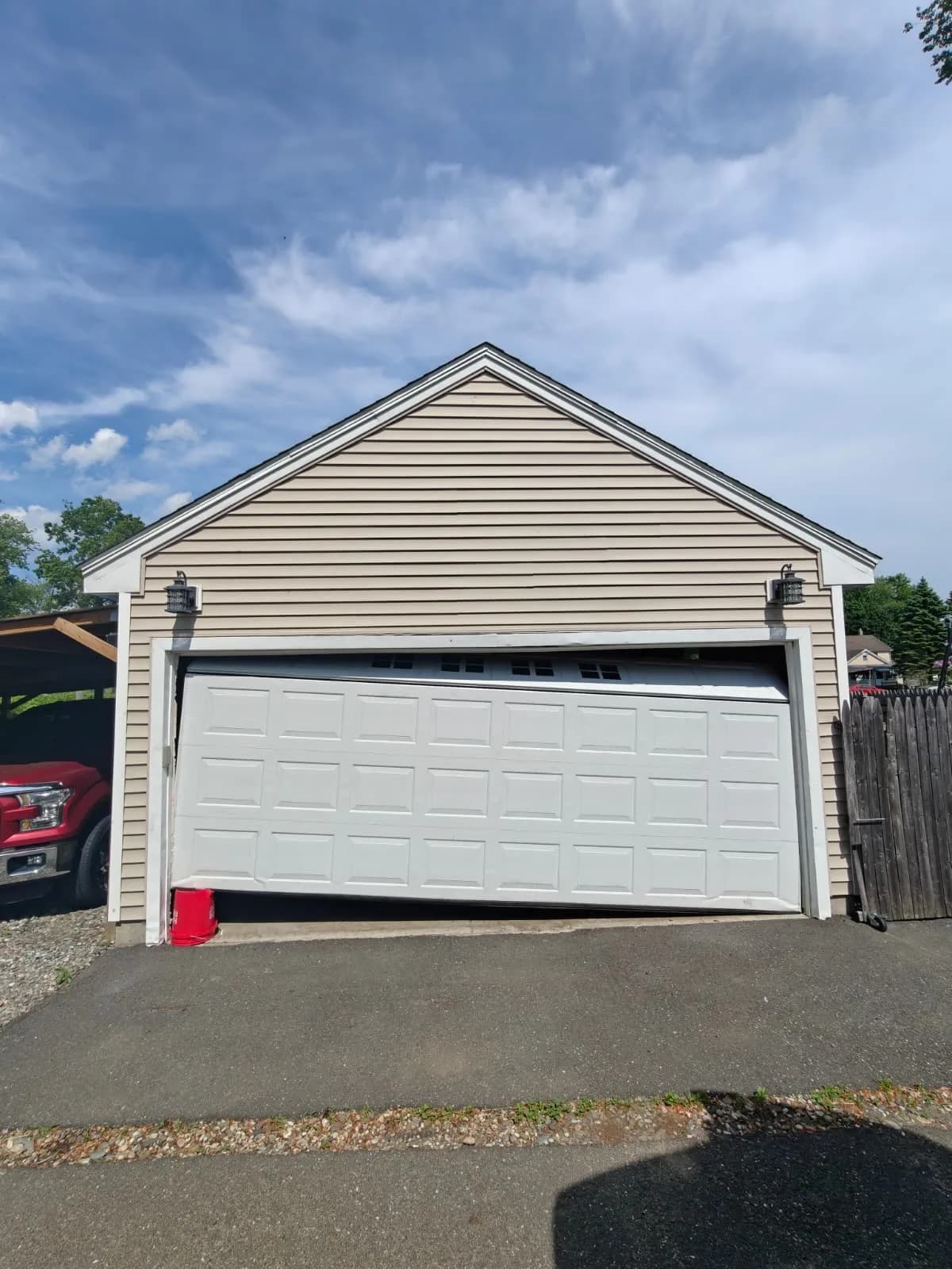 Crooked garage door that has come off its track