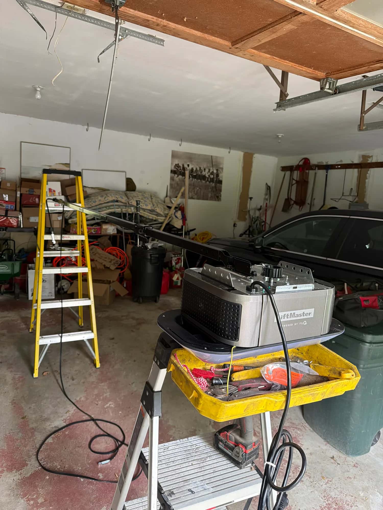 Ladder and opener during a residential garage door repair