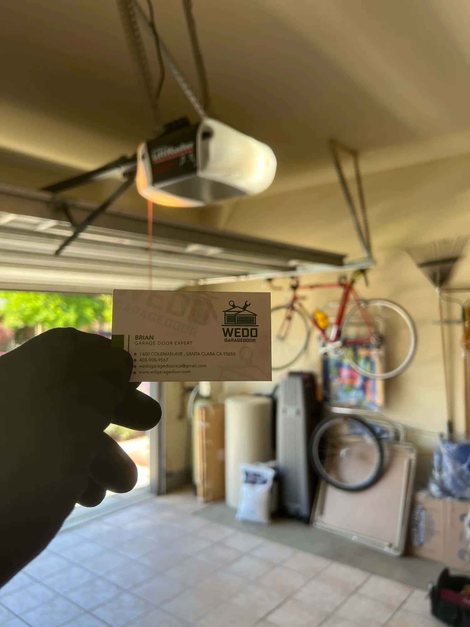 Ceiling-mounted garage door opener during a WeDo service call