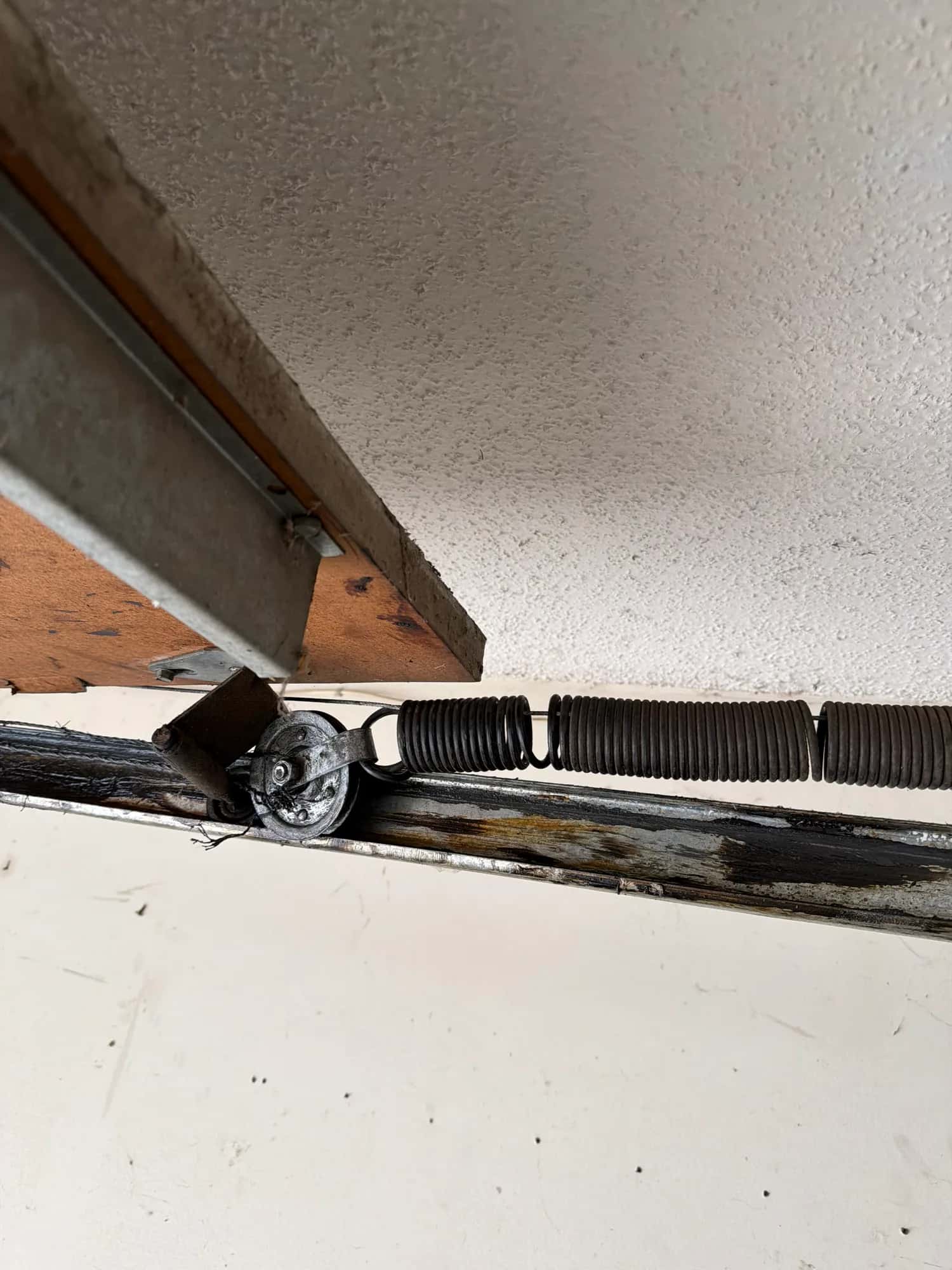 Broken garage door torsion spring with a visible gap in the coil