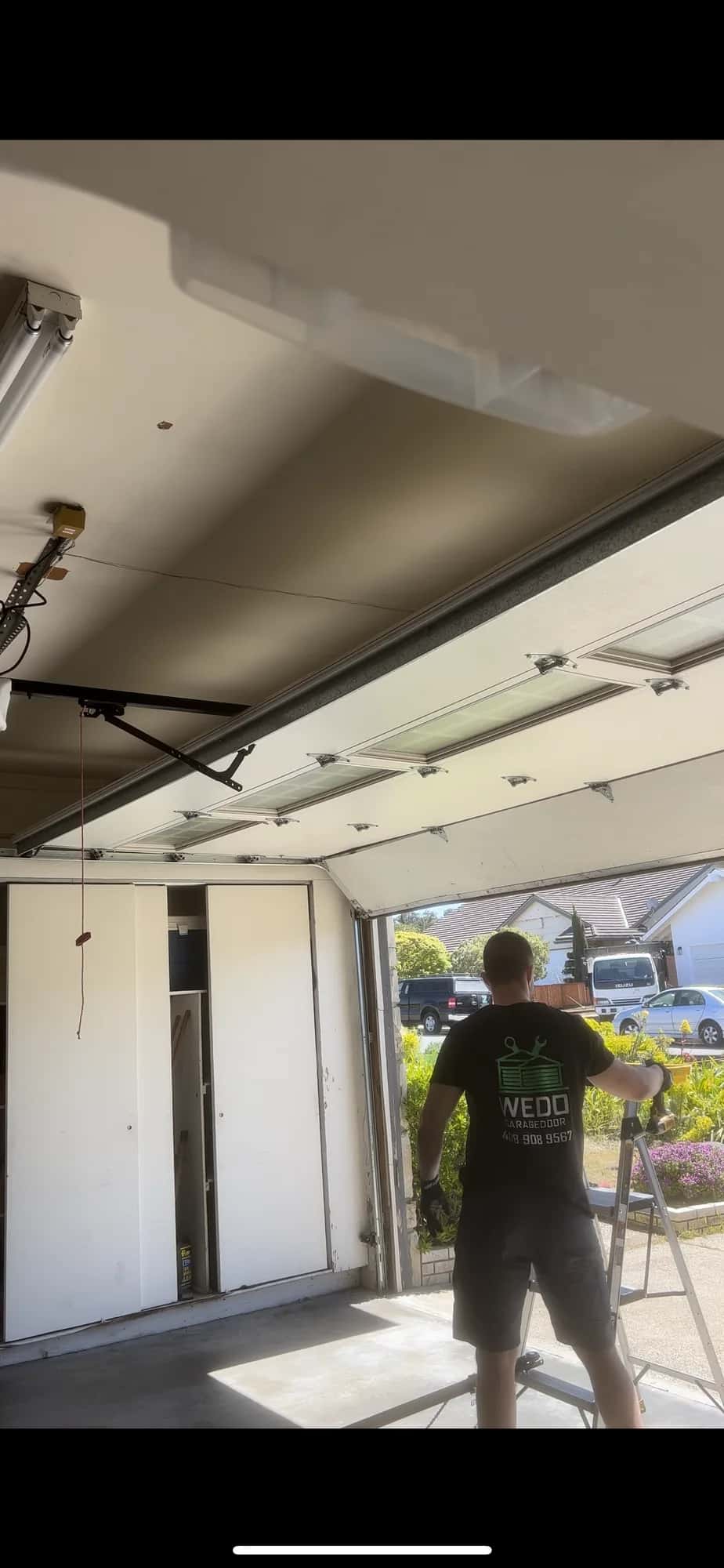 Open residential garage door during a neighborhood service call